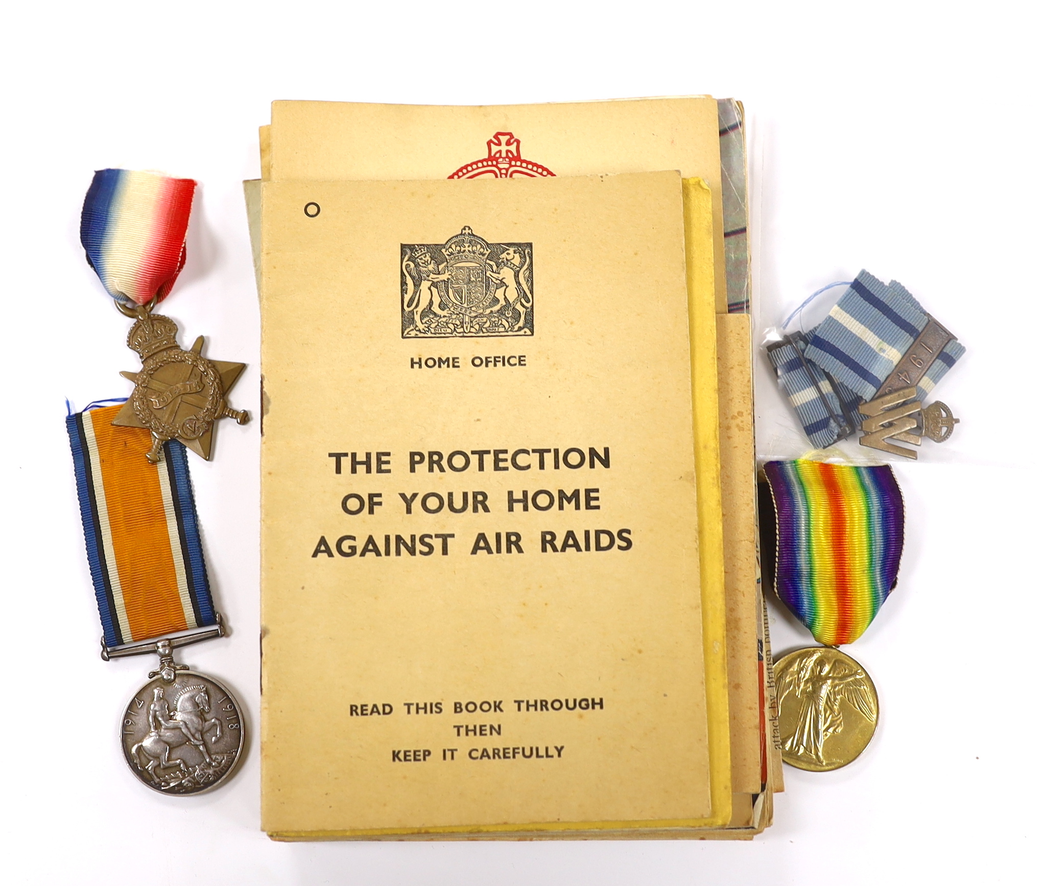 A First World War medal trio to Cpl. E.J. Hannaford, and a small collection of WWII publications including Home Guard instruction booklets, Civil Defence booklets, plus an R.L.S.S. ribbon and a WV badge, etc.